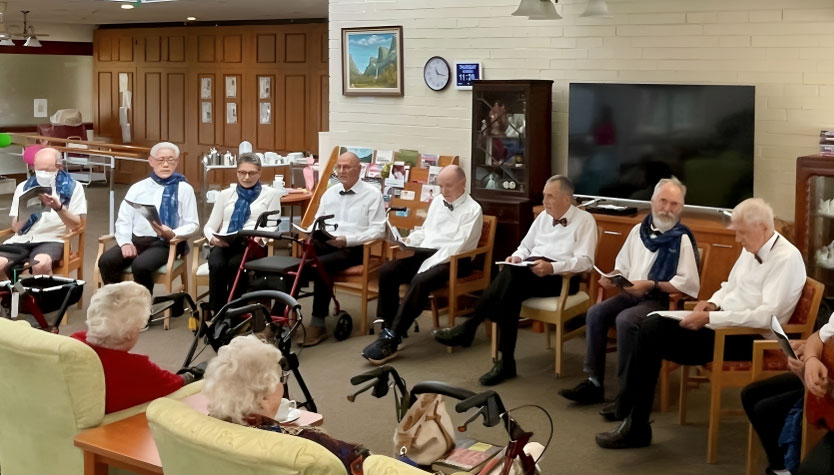 A group of musicians seated, playing a concert